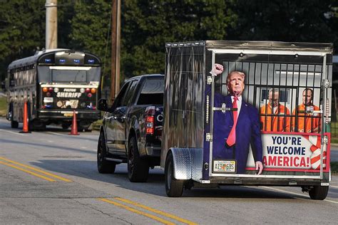 Scores of Trump fans gather outside Georgia jail to show support ahead of his expected surrender